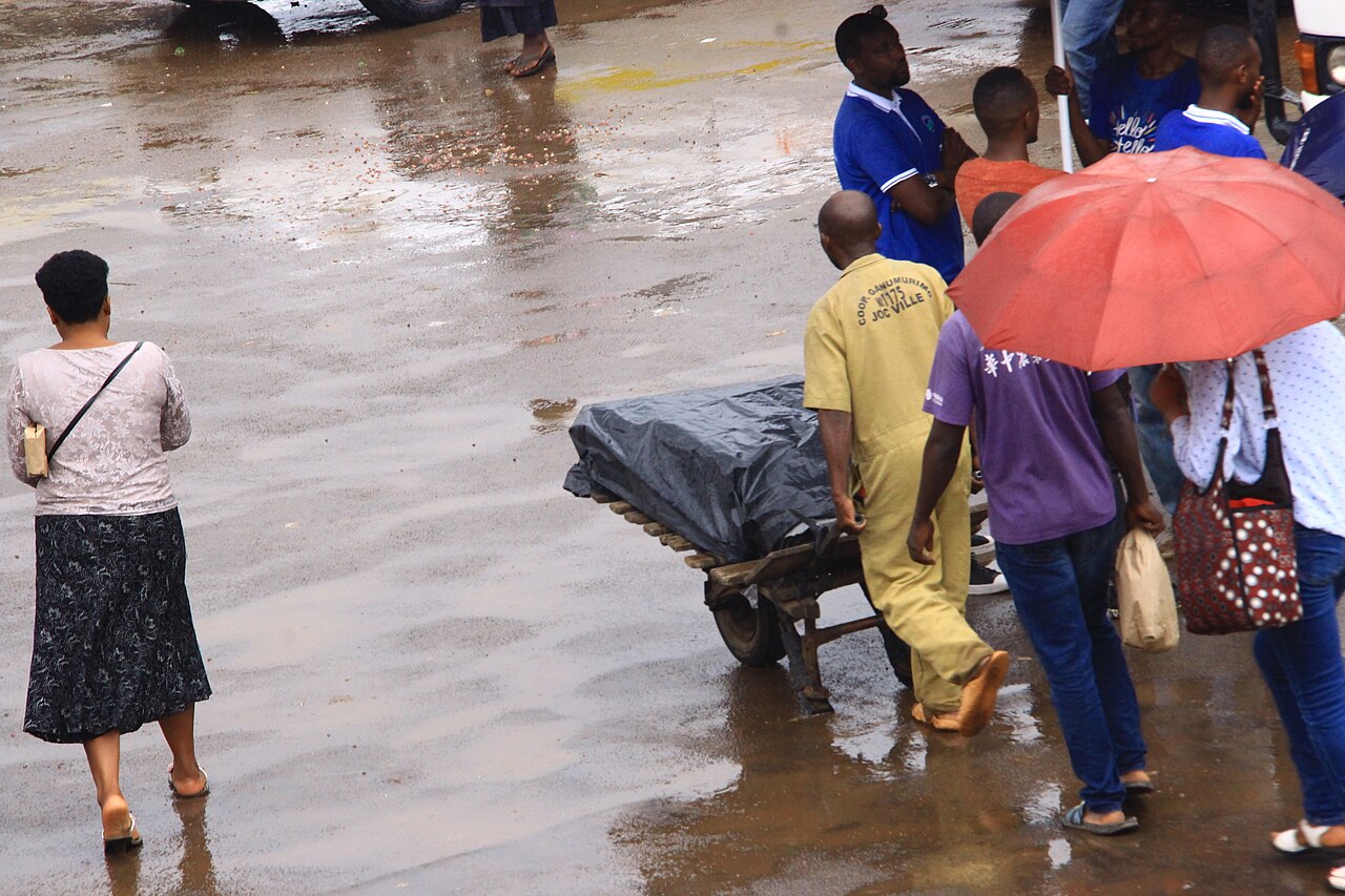 A man pushing a wheelbarrow at Nyabugogo bus park